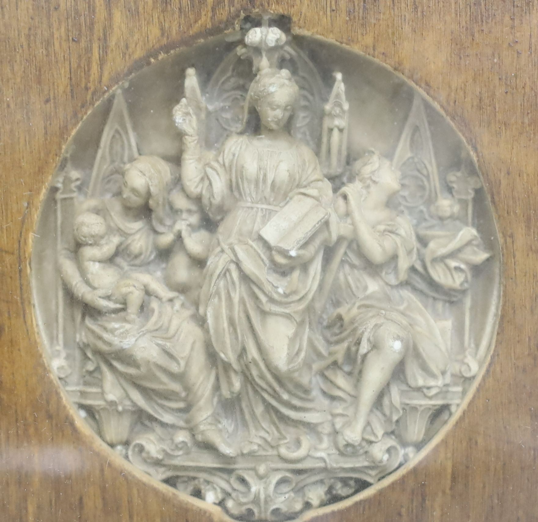 A 19th century Gothic revival plaster relief, depicting figures within altar frame, framed